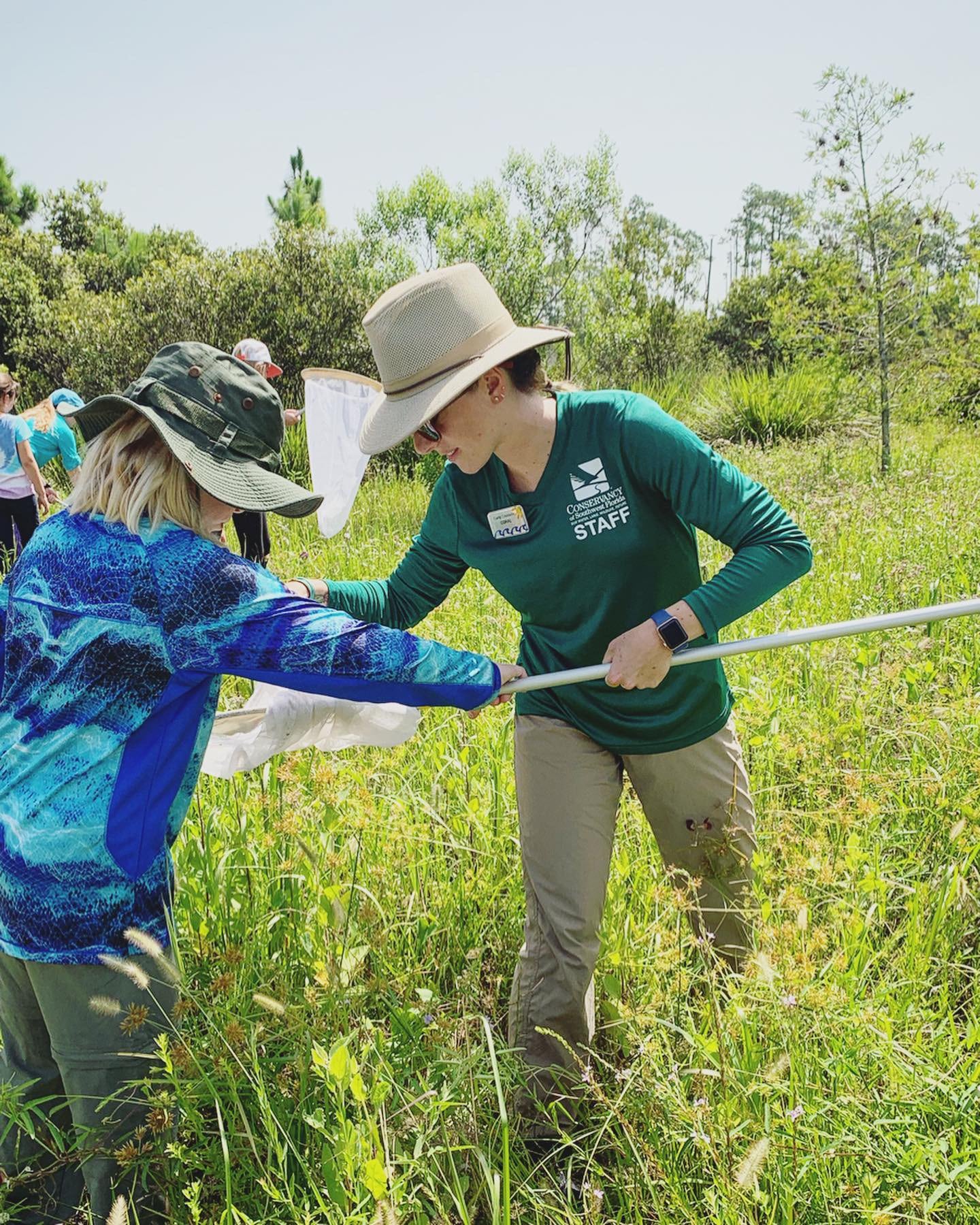 Conservancy of Southwest Florida education staff member checking a butterfly net with a student