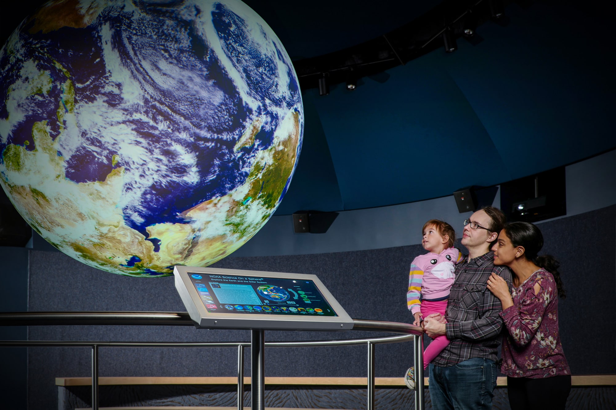 Family in front of Science on a Sphere